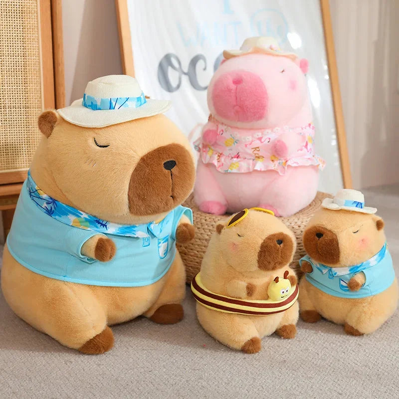 Four Capybara plush soft toys in various sizes and colours. 