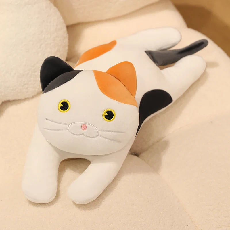 White cat soft toy with grey and orange patches, featuring yellow eyes and a soft plush finish