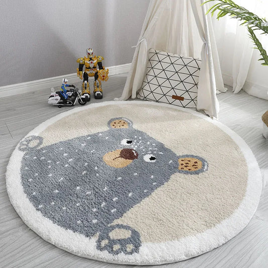Round rug with bear design in a child's room with toys and a pillow.
