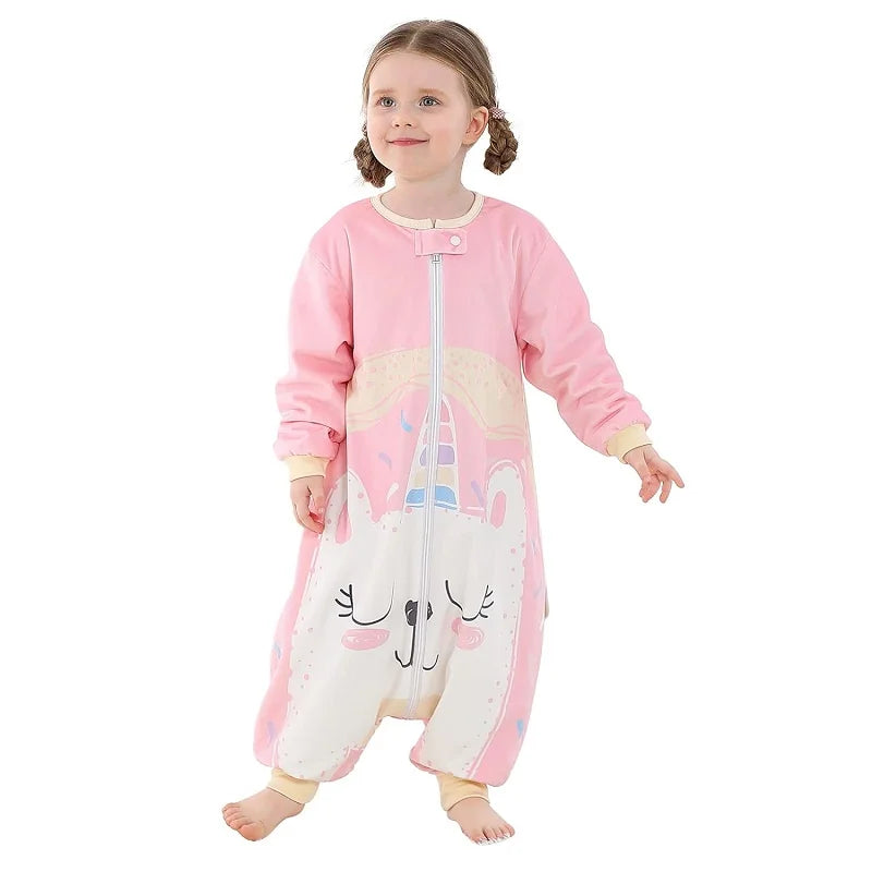 Child wearing a pink and white onesie with a cartoon unicorn design on a white background