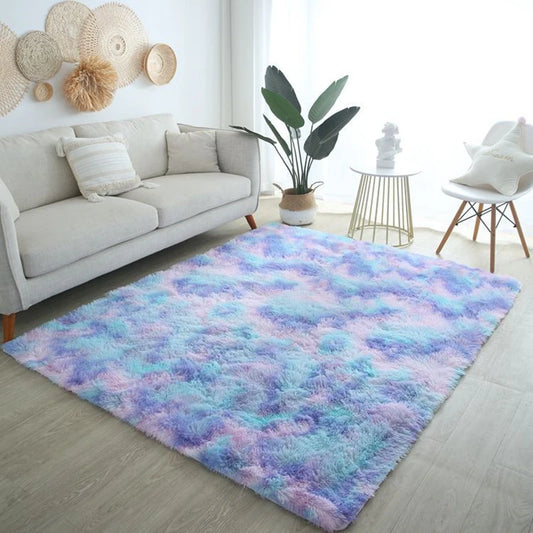 Blue and purple tie-dye rectangular plush rug placed on the floor in a bright living room