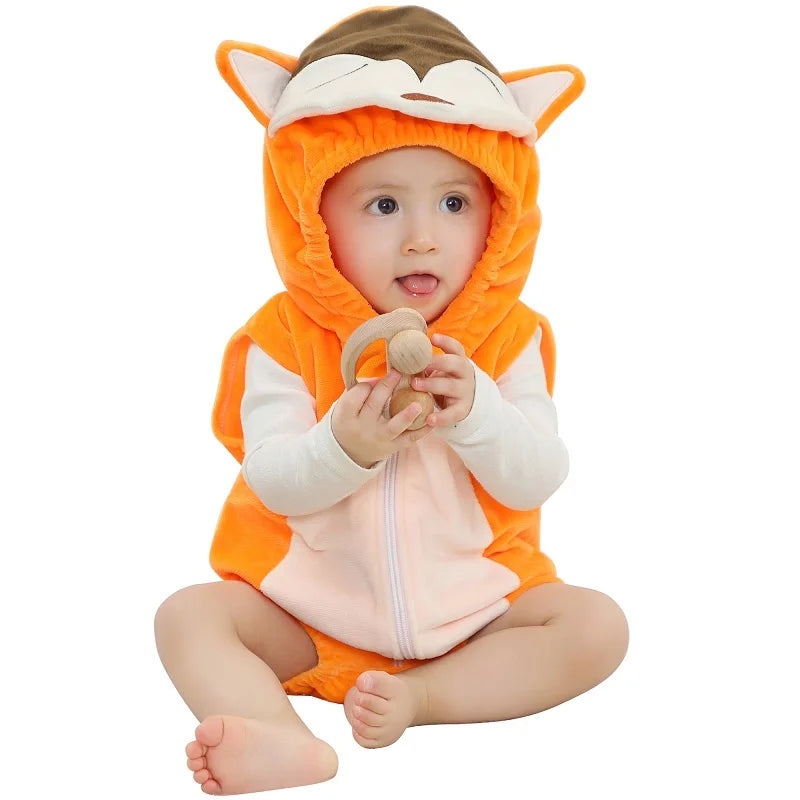 Baby wearing a fox hooded onesie on a white surface. 