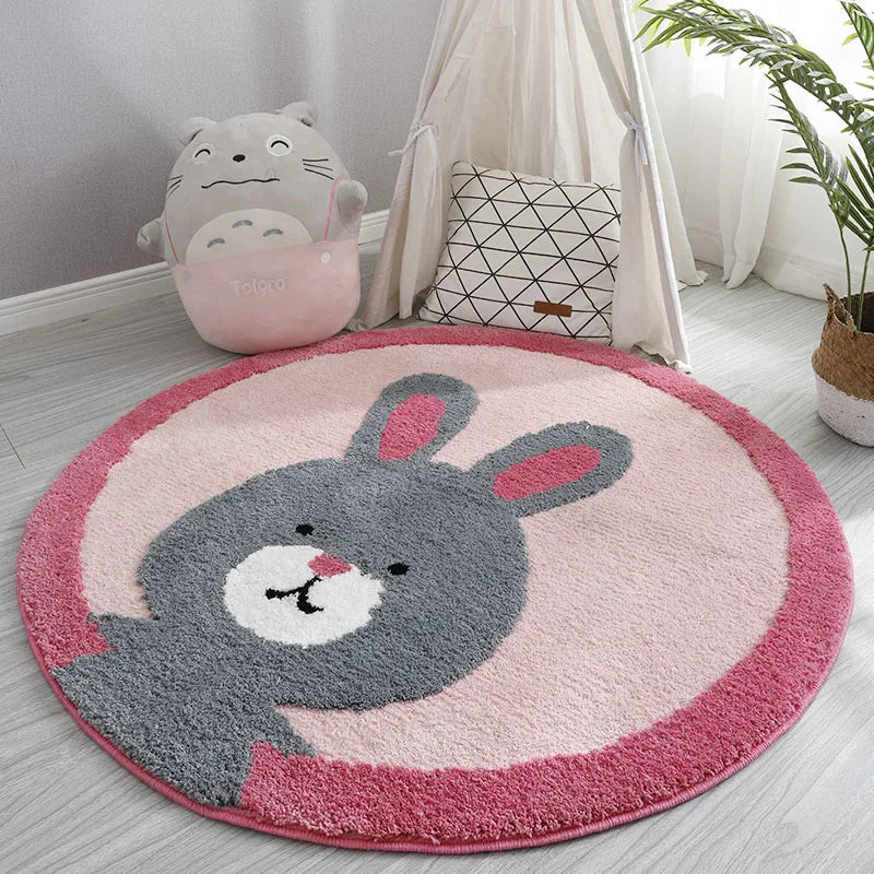Round children's rug with a bunny design on a light wooden floor.