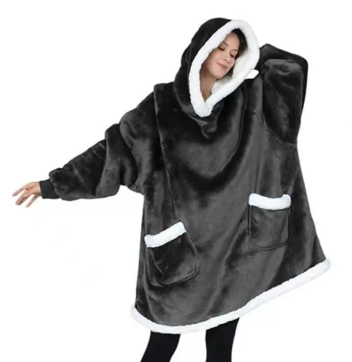 Woman wearing a black thick oversized hoodie on a white background.