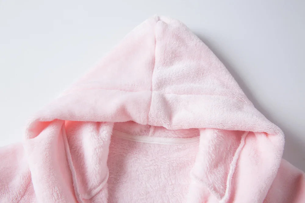 Close up of a pink hood on a kids bath robe on a white background