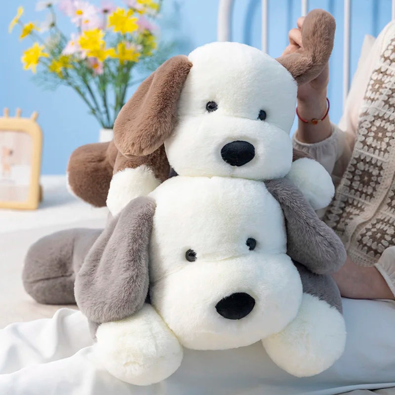 Two plush dog toys stacked on top of each other with a blurred background