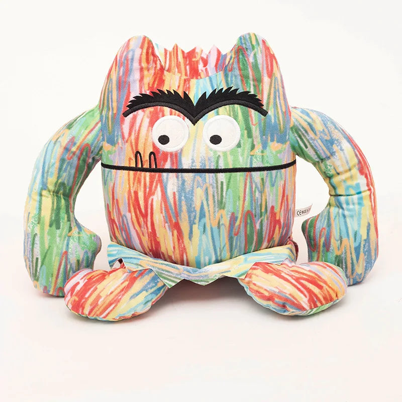 Colourful soft plush monster toy on a white background.