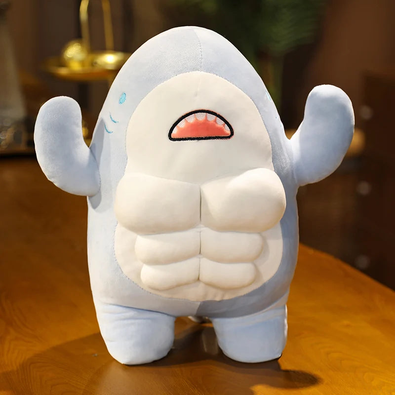 Blue soft plush muscular shark toy standing on a wooden surface.