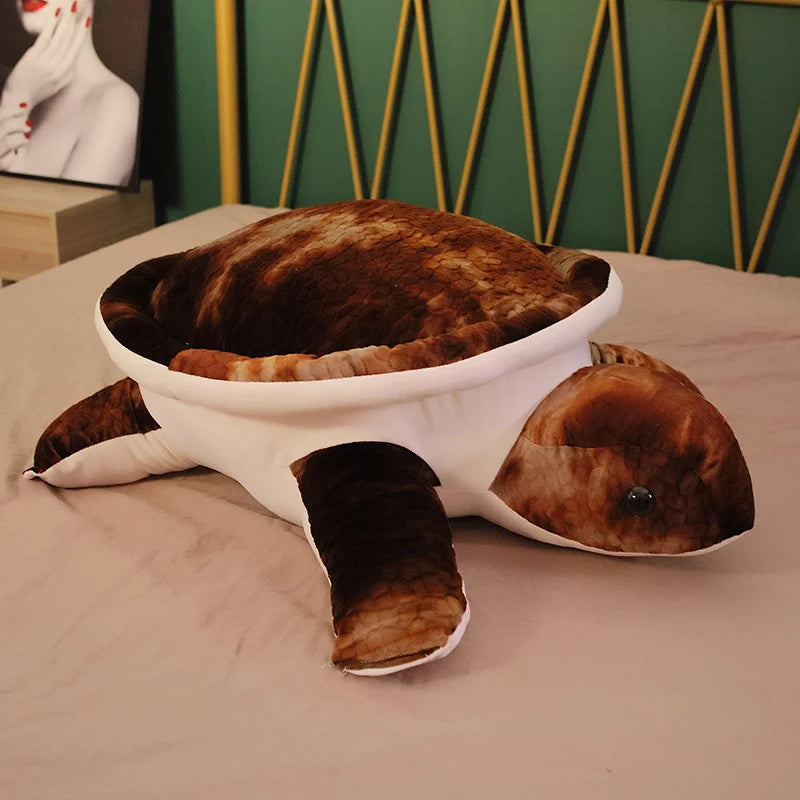 Brown soft plush turtle toy on a bed.