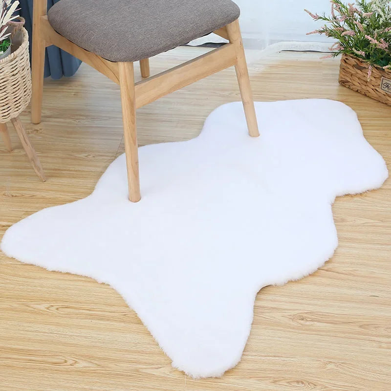 White fun-shaped faux rabbit fur rug placed on a wooden floor beneath a chair