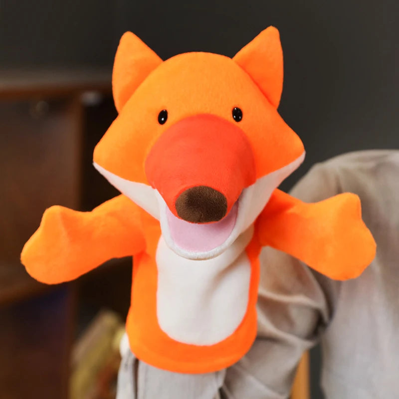 Orange fox plush hand puppet with a blurred background
