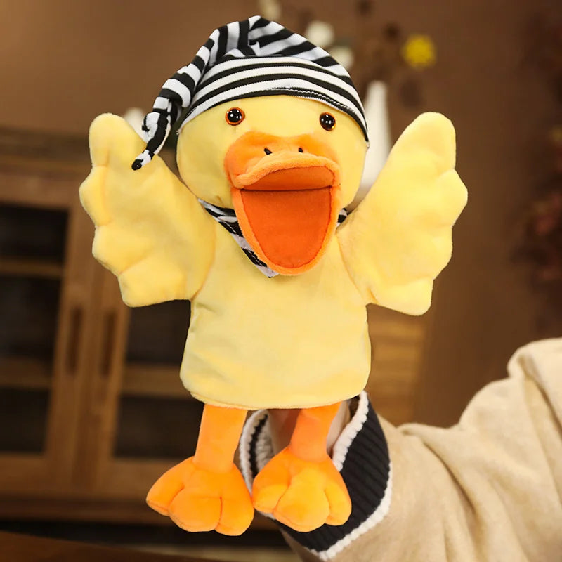Plush duck hand puppet with a striped hat held by a person