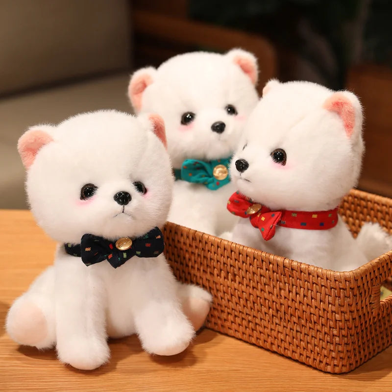 Three white plush toys with colourful bow ties in a woven basket on a wooden surface.