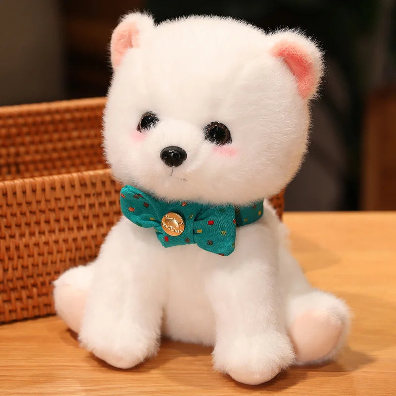 White teddy bear with a green bow tie sitting on a wooden surface.