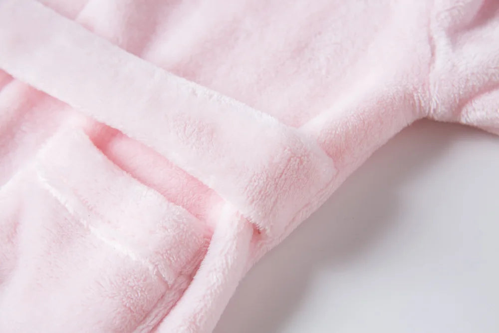 Close up detailing of a pink kids bath robe's tie.