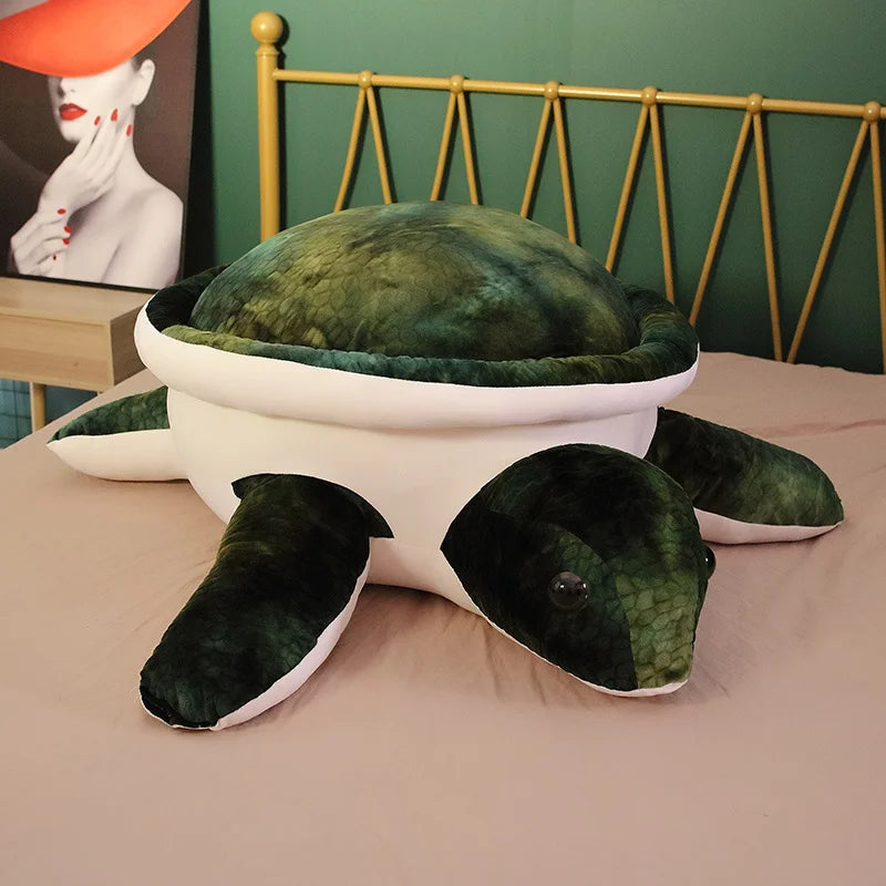 Dark green soft plush turtle toy on a bed.