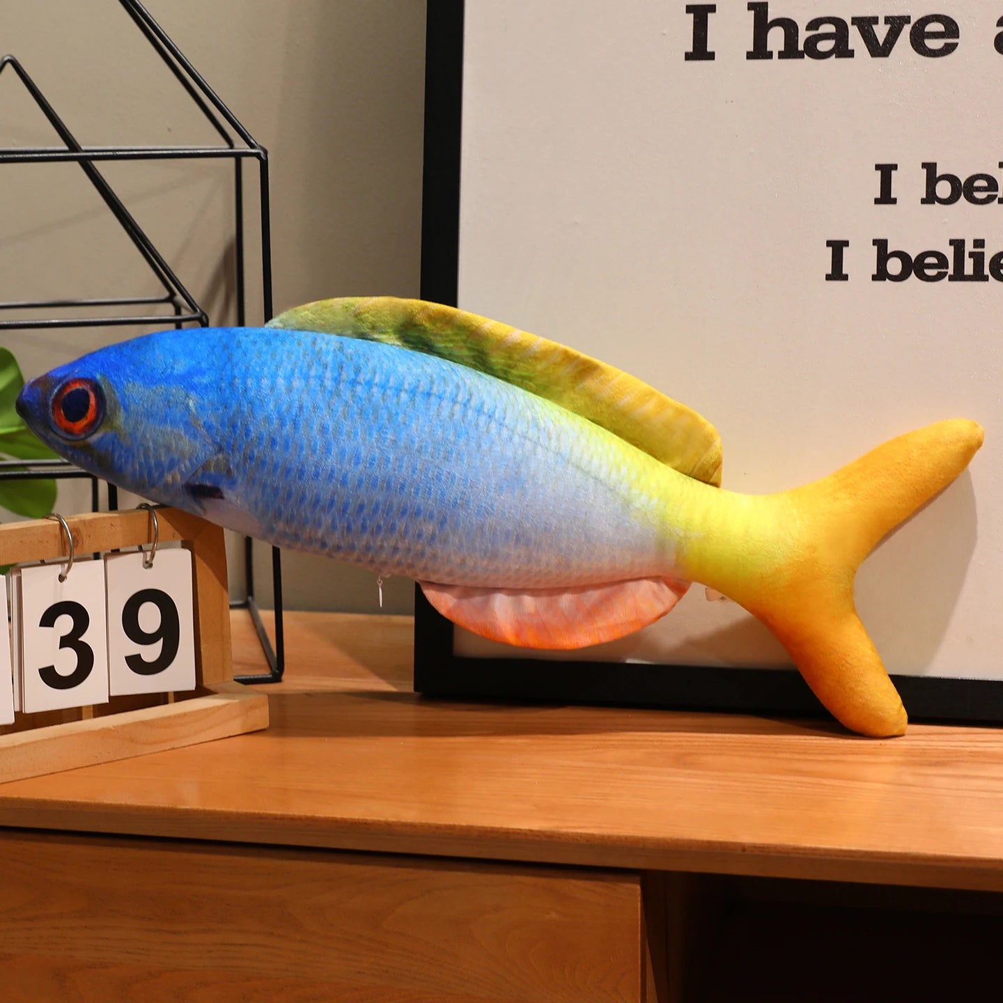 Blue and yellow fish soft toy with a realistic printed scale pattern