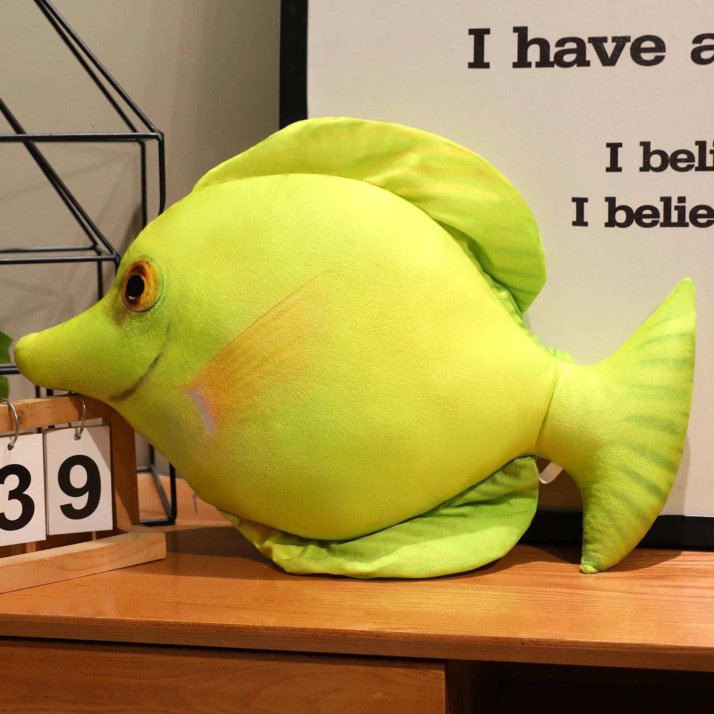 Green fish soft toy with a realistic printed design and green fins