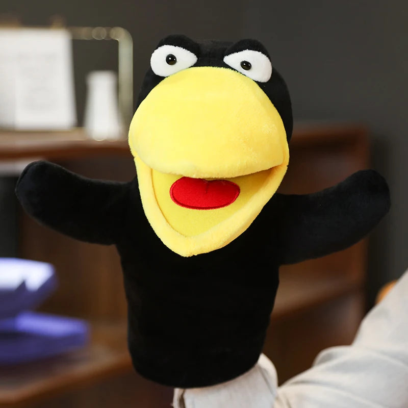 Black and yellow plush hand puppet with a red mouth in a blurred indoor setting