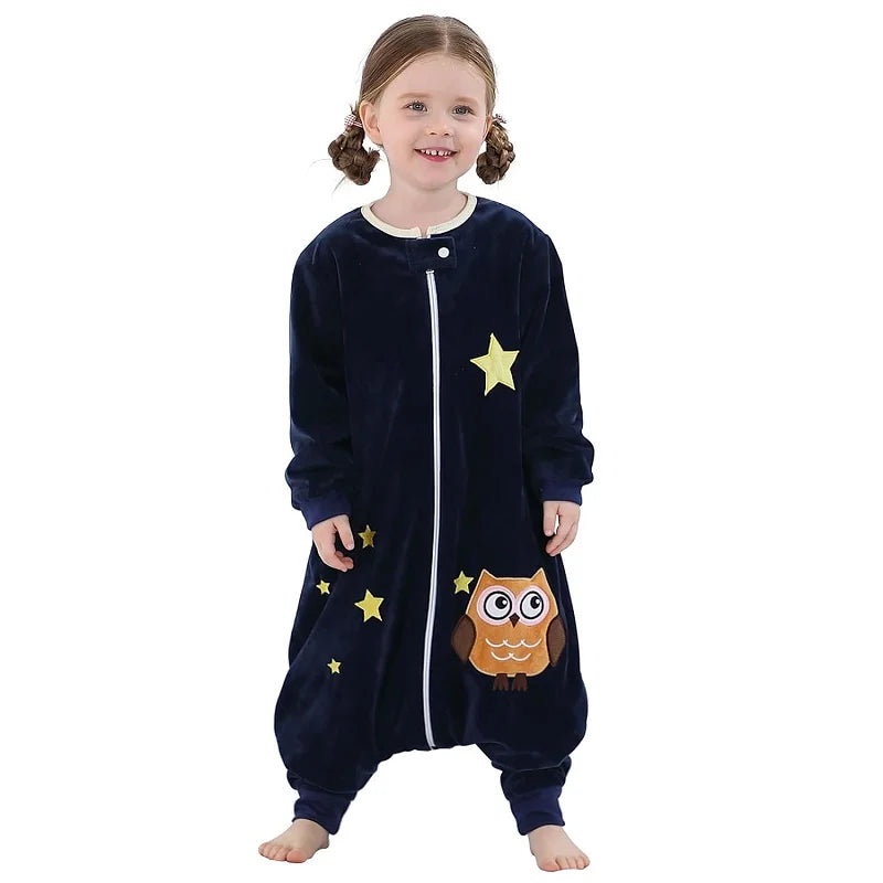 Child wearing a navy blue onesie with owl and star designs on a white background