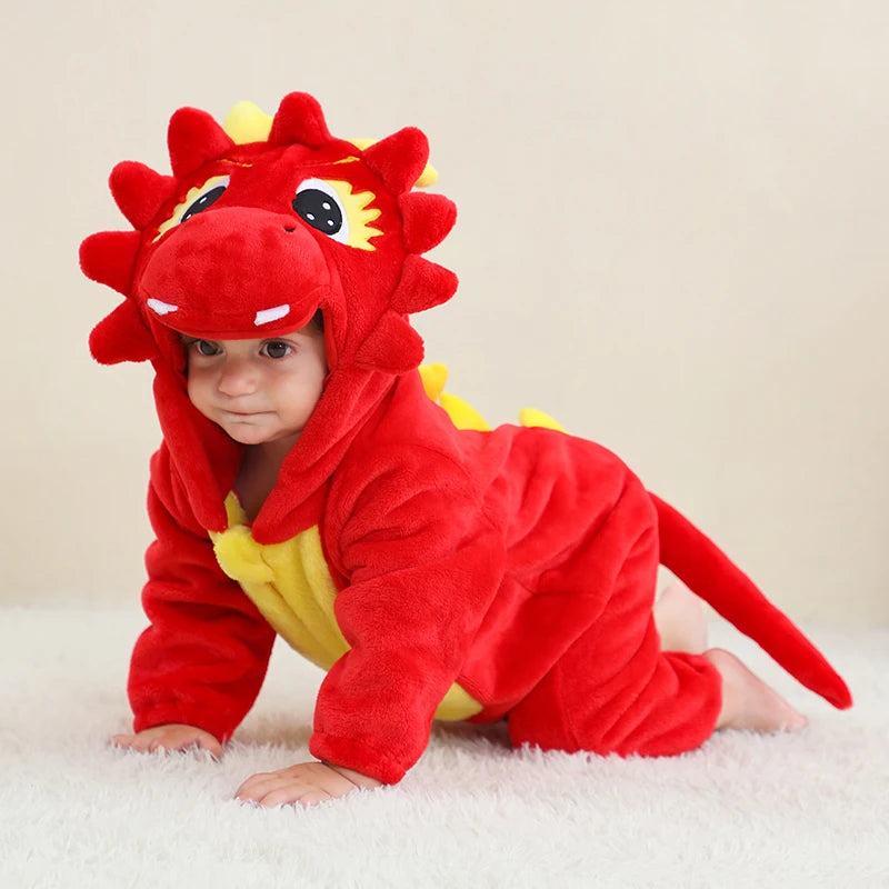 Child wearing a red dragon onesie on a light background
