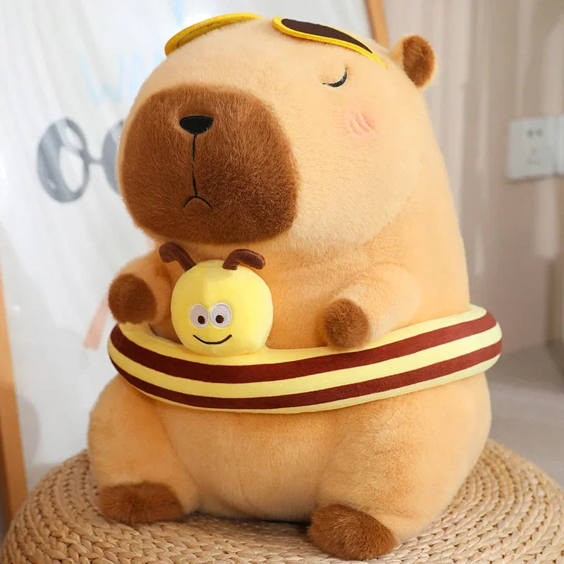 Brown capybara plush soft toy with a striped bumble bee band.