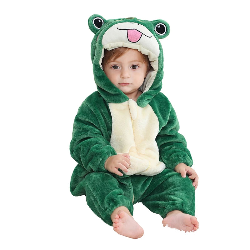 Child wearing a green frog onesie on a white background