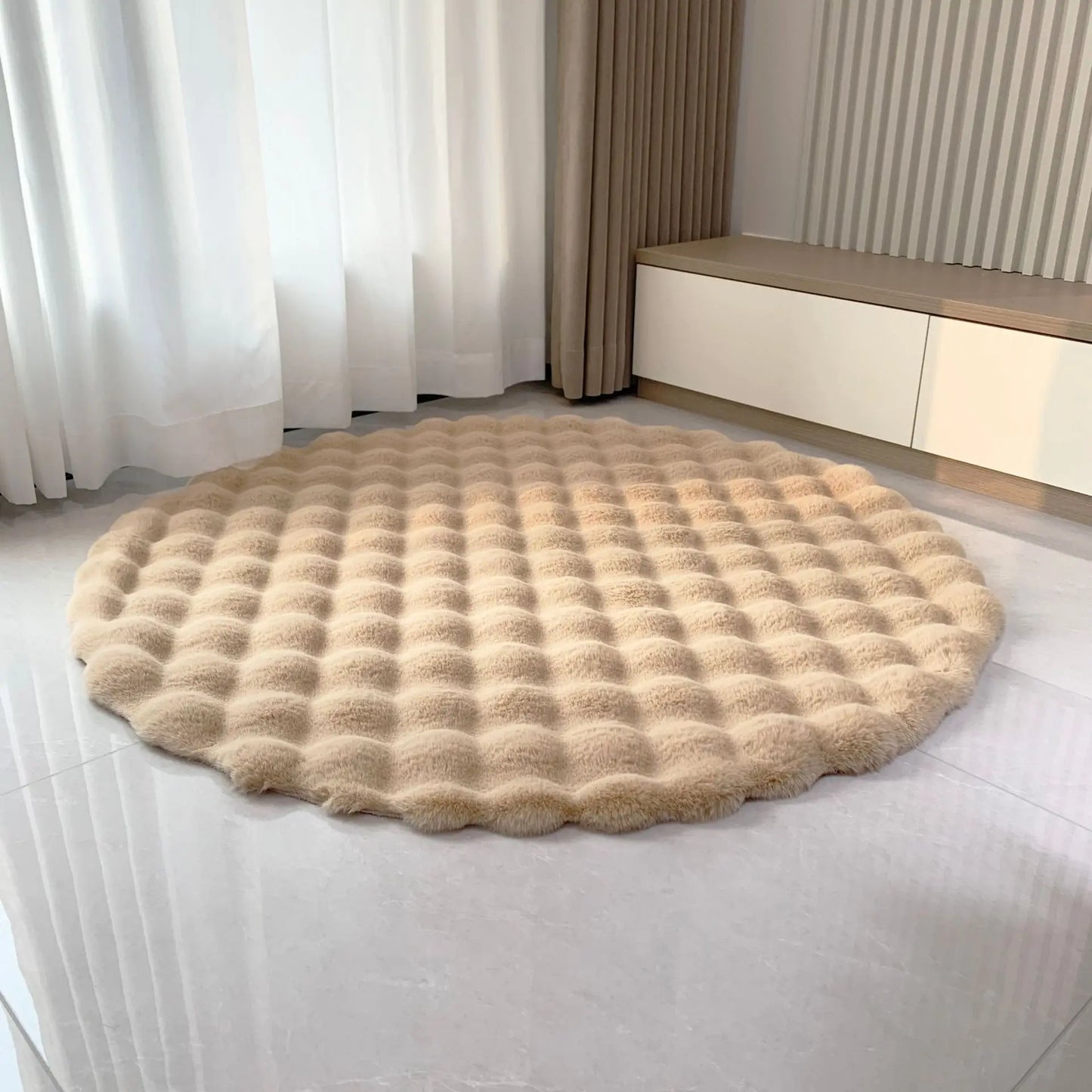 Beige round bubble velvet plush rug shown on a light floor in a bright modern room
