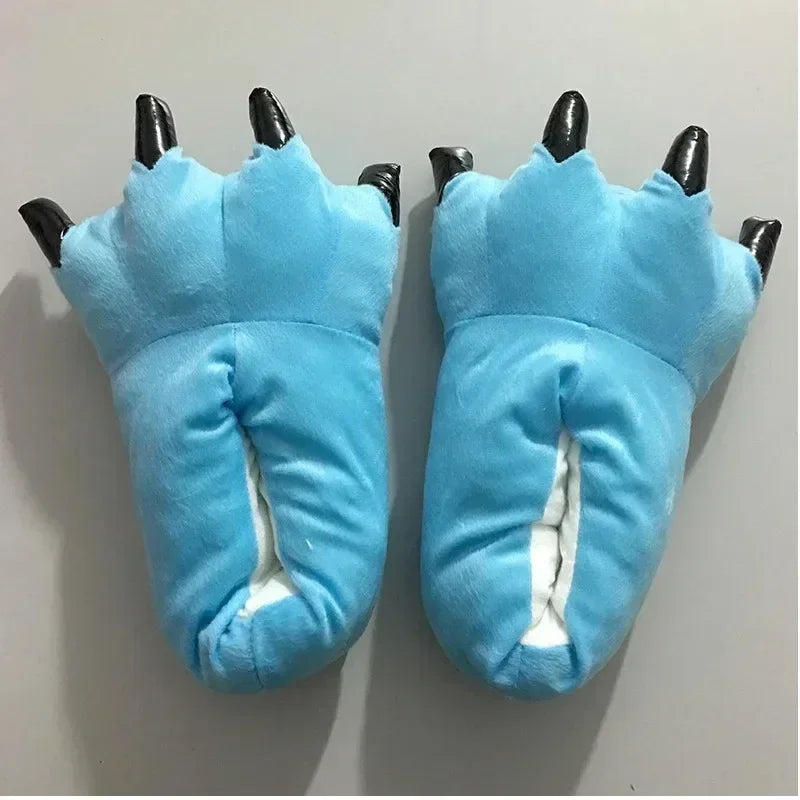 Blue paw-shaped slippers with black claws on a light grey background
