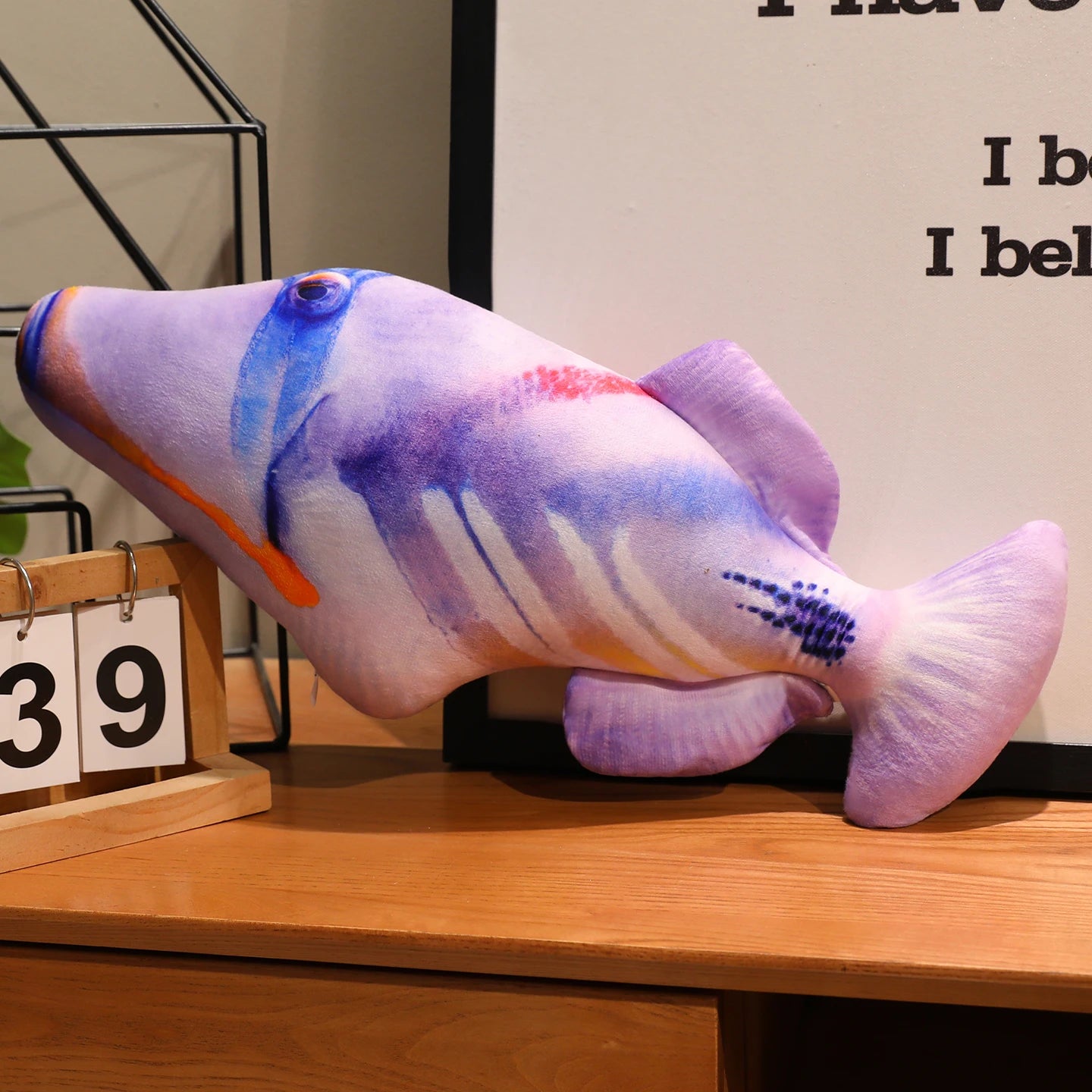 Purple fish soft toy with a realistic printed pattern and purple fins