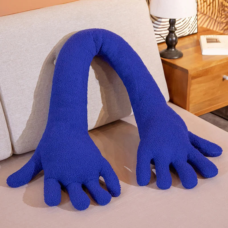 Blue soft plush simulation hand on a couch.