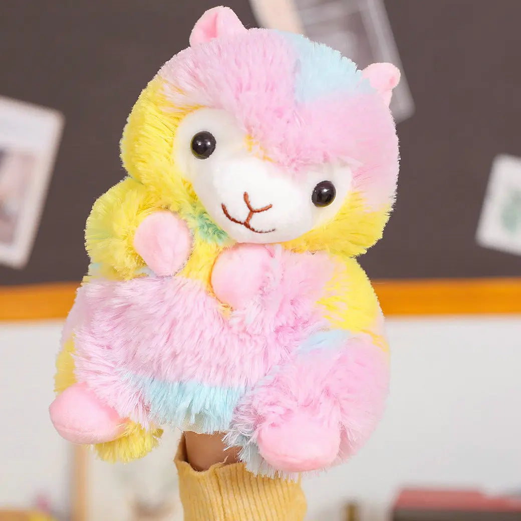 Colourful plush hand puppet resembling a llama held by a person against a blurred indoor background