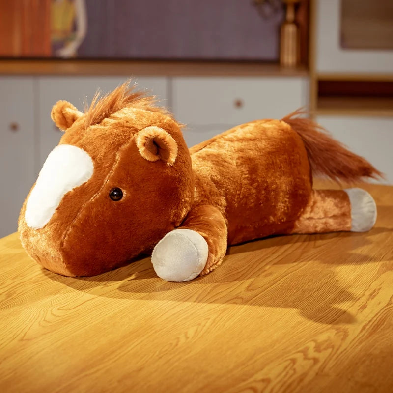 Plush horse toy on a wooden surface with a blurred background