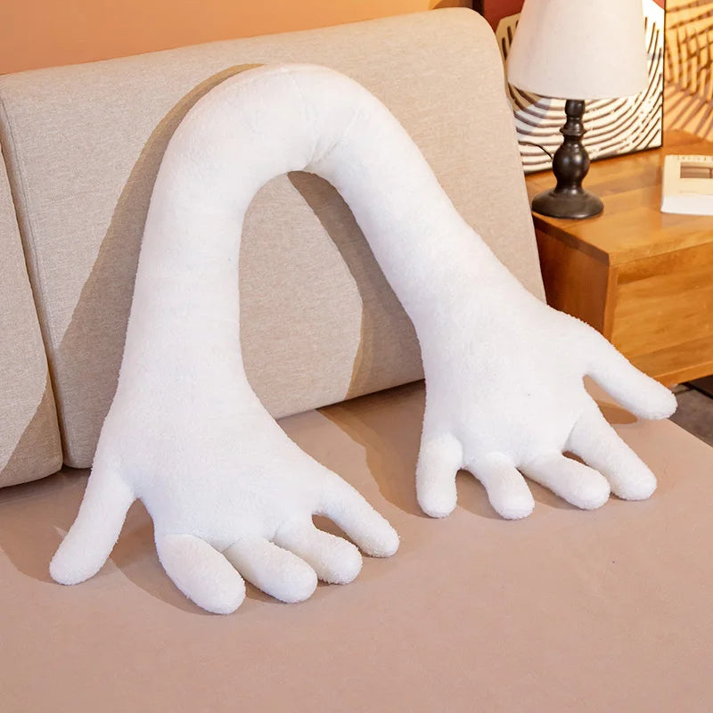White soft plush simulation hand on a couch.