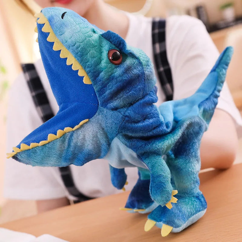 Blue plush dinosaur hand puppet with yellow accents on a blurred background