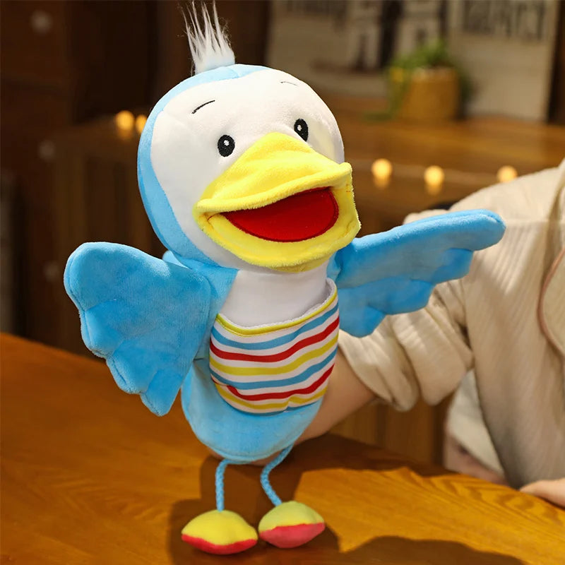 Plush toy duck hand puppet with a colourful striped shirt on a wooden table
