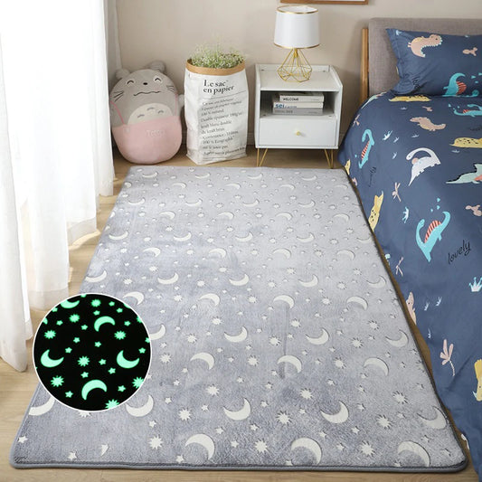 Grey rug with moon and star pattern in a room with a bed and nightstand.