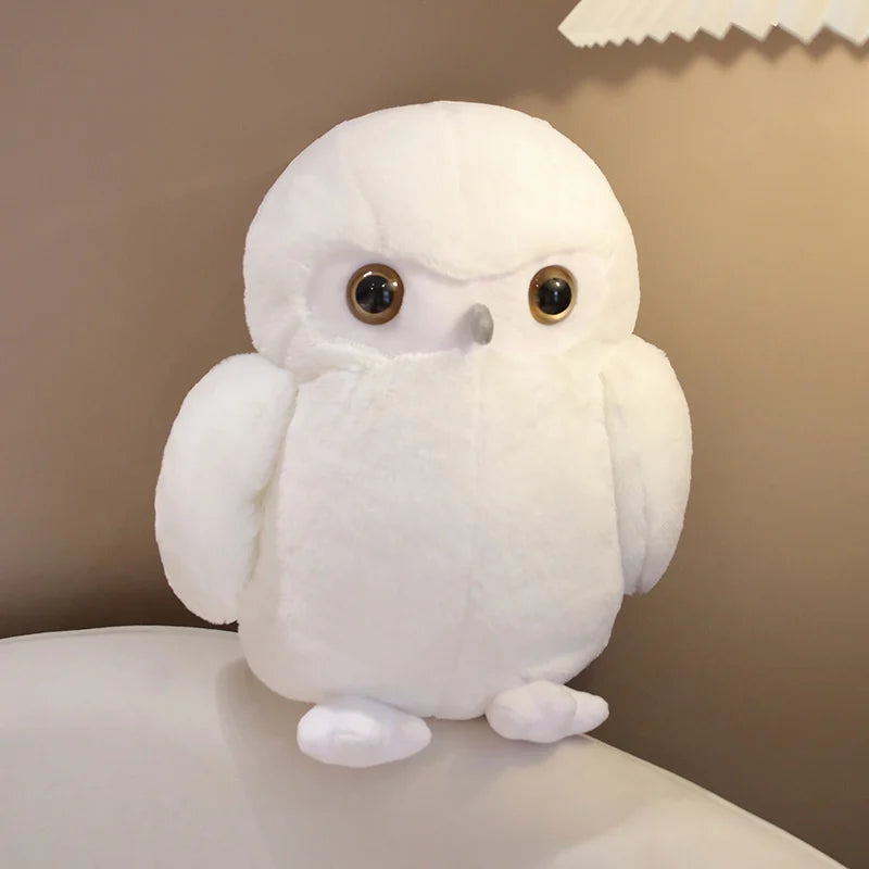 White owl plush toy on a neutral background