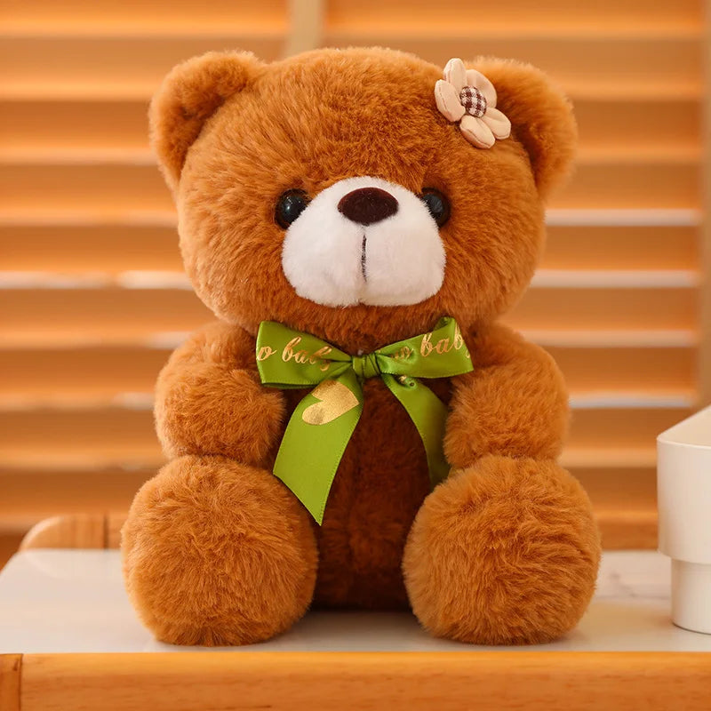 Brown soft plush teddy bear sitting on a wooden surface