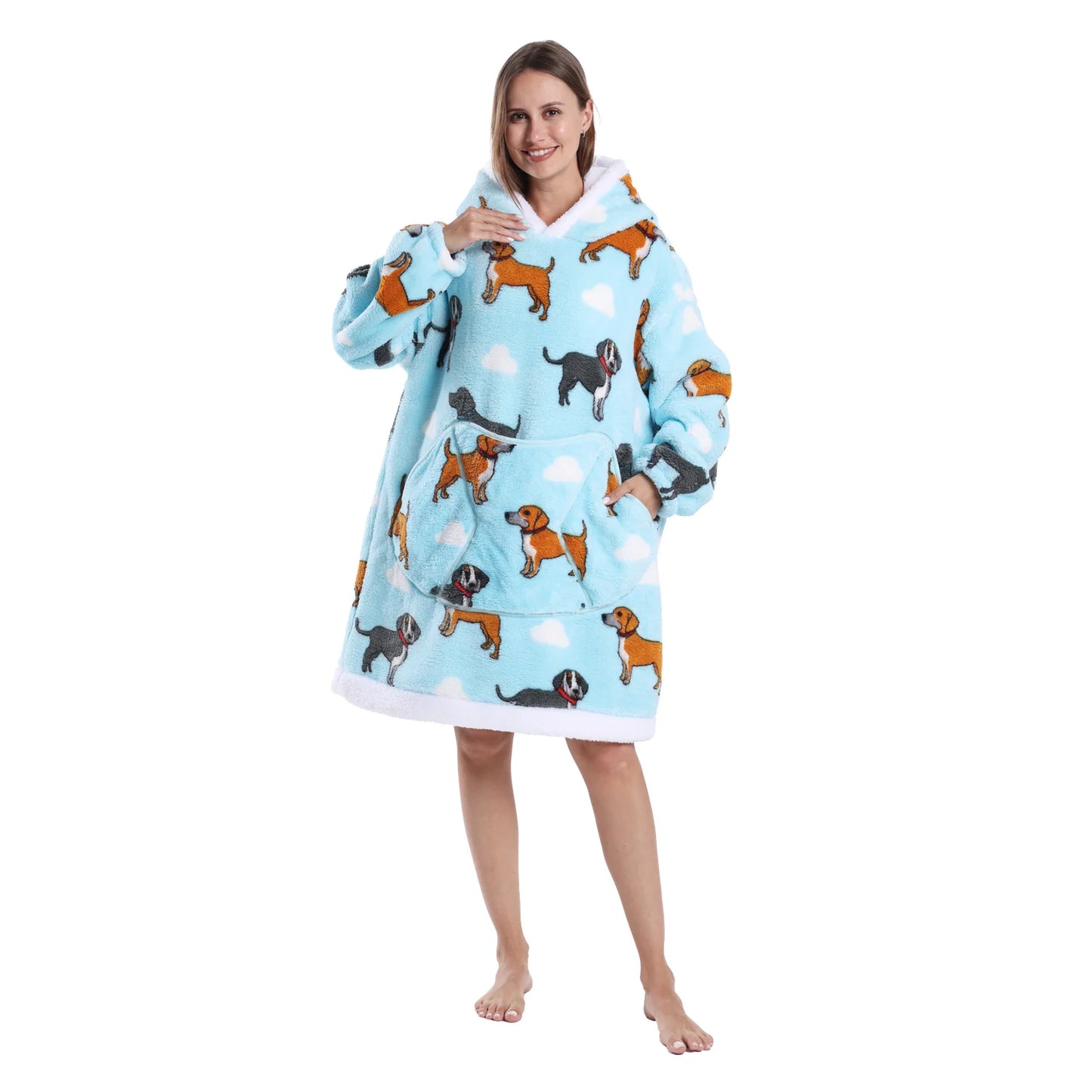 Woman wearing a blue oversized lounge hoodie with dog motifs on a white background