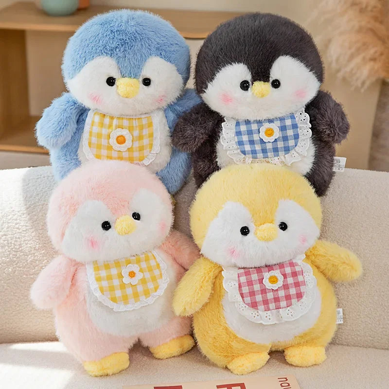 Fluffy penguin plush toys in blue, pink, yellow, and black with soft rounded bodies and cute character details