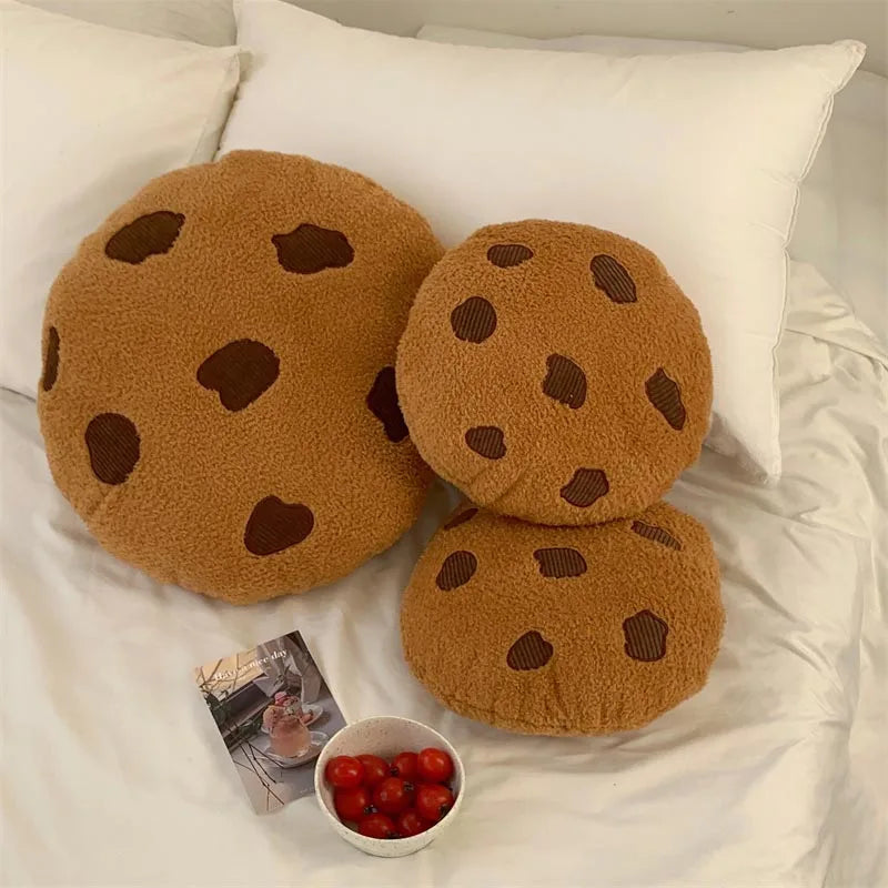 Chocolate chip cookie soft toy set with smiling faces, styled on a bed with small decorative accessories