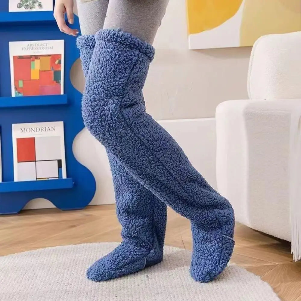 Person wearing blue fuzzy socks in a living room setting