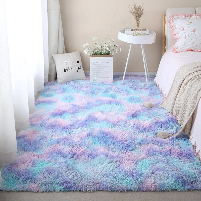 Blue and purple tie-dye rectangular plush rug placed on the floor in a bedroom