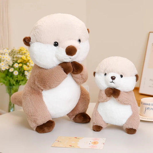 Otter soft toy set with large and small plush toys, featuring white bellies and brown paws on a table