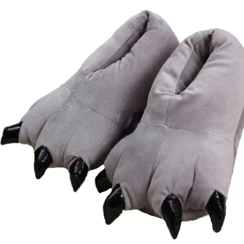 Grey paw-shaped slippers with black nails on a white background