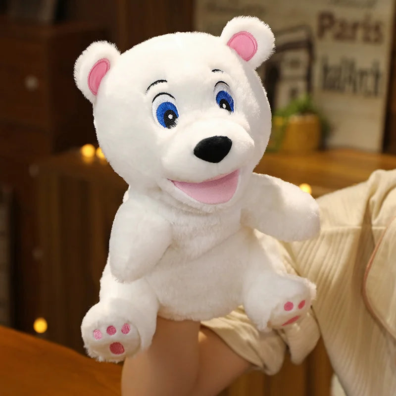 White plush hand puppet bear with pink paws held by a person in a blurred indoor setting