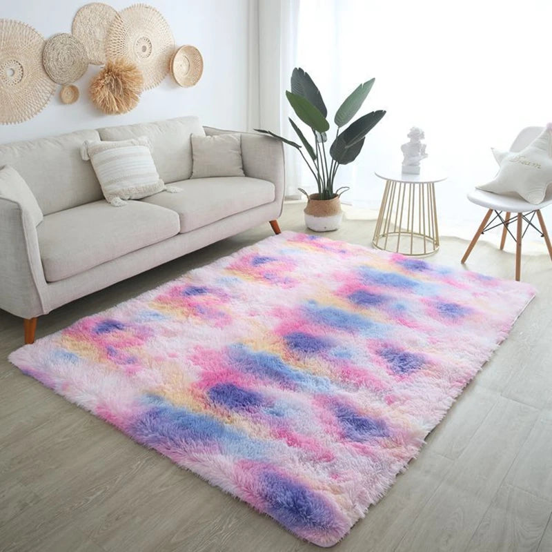 Pink and purple tie-dye rectangular plush rug placed on the floor in a bright living room