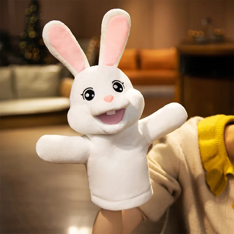 White rabbit plush hand puppet held by a person in a blurred indoor setting