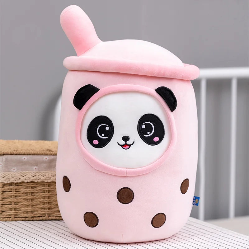Plush toy shaped like a pink bubble tea with a panda face on a neutral background